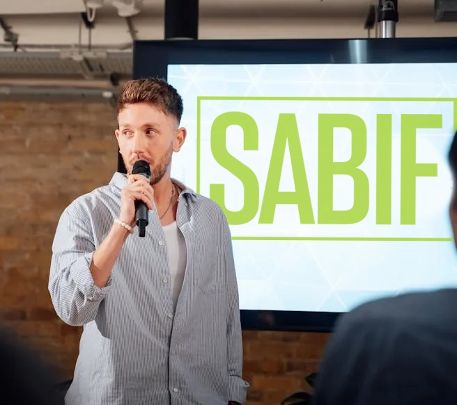 Man presenting in front of a screen